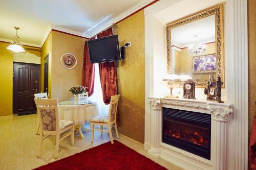 a living room with a fireplace and a table at Apartments Lux in city center Lviv in Lviv