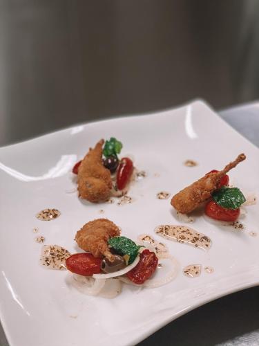 a plate of food with chicken and vegetables on it at Relais Villabella Hotel in San Bonifacio