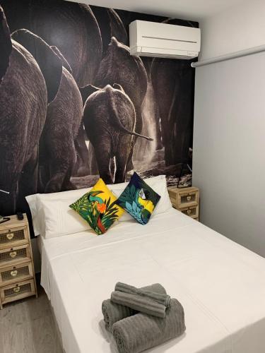 a bedroom with a bed with a mural of elephants at T-Homes - Fuencarral in Madrid