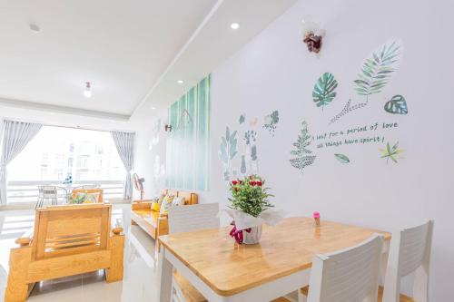 a living room with a dining room table and a table and chairs at Qvungtau-3BR Oasky- Seaview apartment Vung Tau in Vung Tau