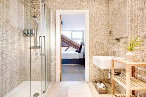 a bathroom with a shower and a sink at Penthouse Loft apartment with roof terrace Not for events or parties in London