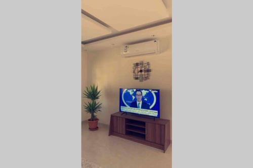 a living room with a television on a table at Luxury fully furnished villa ڤيلا مؤثثة in AlUla