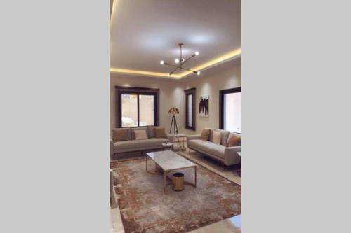 a living room with a couch and a table at Luxury fully furnished villa ڤيلا مؤثثة in AlUla