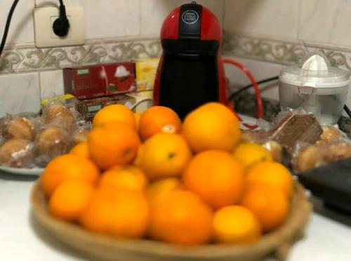 a bowl of oranges on a counter in a kitchen at JACOB'S HOSTEL TUI in Tui