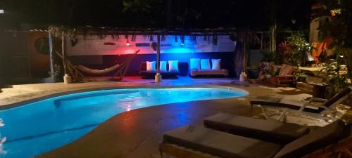 a large swimming pool at night with blue lights at Massai Apartments in Playa Flamingo