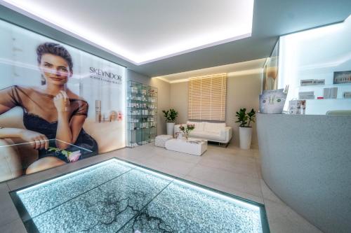 a room with a glass shower with a picture of a woman at Hotel Meta Resort & Vine SPA in Szczyrk
