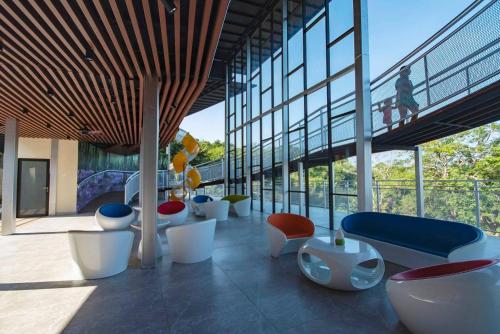 a room with a bunch of chairs in a building at MyRus Resort Langkawi in Pantai Cenang