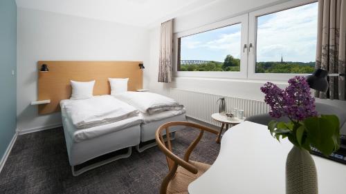 um quarto de hotel com uma cama e uma janela em Trinity Hotel og Konference em Fredericia