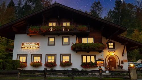 a white building with a sign in front of it at Ferienhaus Wetterstein in Grainau