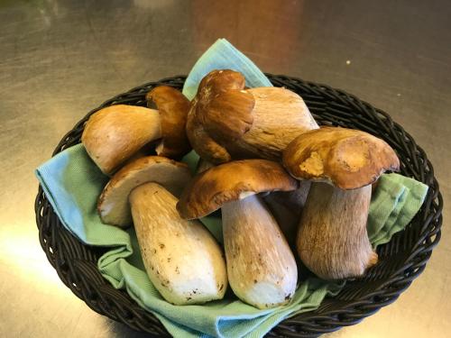 a basket full of mushrooms on a table at Hotel Stüa Granda in Soglio