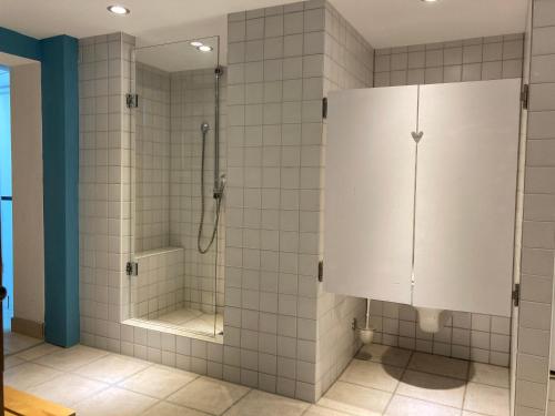 a tiled bathroom with a shower and a toilet at Ferienhaus Valentin in Oberammergau in Oberammergau