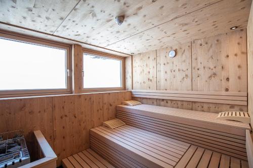 a sauna with two benches in a wooden room at Urbanhof in Sölden