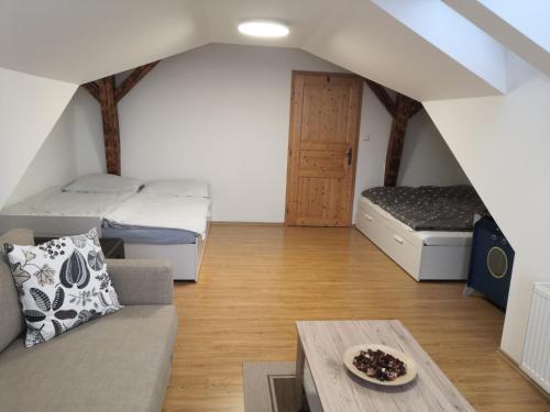 a living room with two beds and a couch at Apartment Lipno Šumava pro 8 hostů in Lipno nad Vltavou
