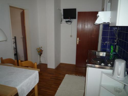 a small kitchen with a table and a room with a table at Villa Sandra Hvar in Hvar