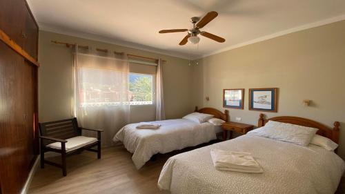 a bedroom with two beds and a ceiling fan at Casa Camilo I in Valle Gran Rey