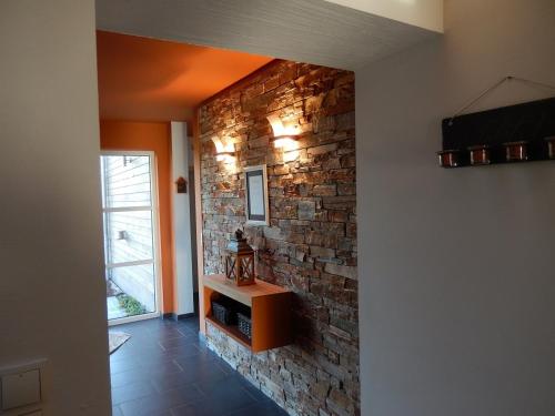 a room with a stone wall and a brick wall at Gîte du Moulin - Rose in Trois-Ponts