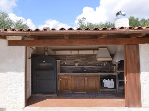 a kitchen under a pergola with a stove at Villa Eureka by Interhome in Solarino