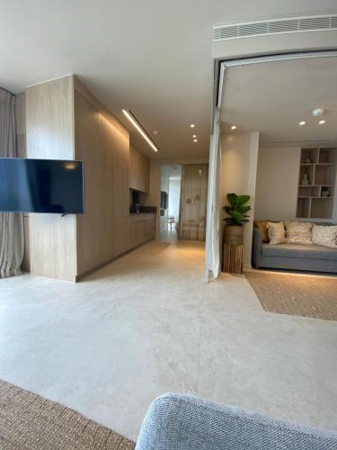 a living room with a flat screen tv on a wall at daniel hotel beach view boutique apt in Herzliya