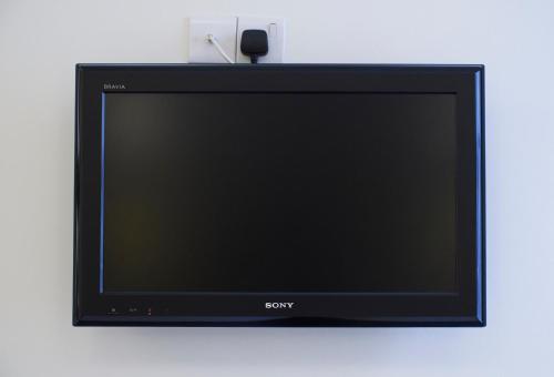 a flat screen tv sitting on a wall at Luna And Simone Hotel in London