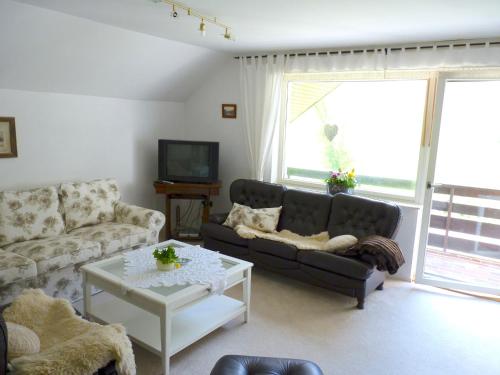 a living room with a couch and a coffee table at Apartments Green Paradise in Bohinjska Bela