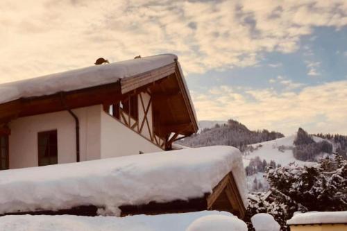 a house covered in snow on top of a mountain at Haus Andreas in Kitzbühel