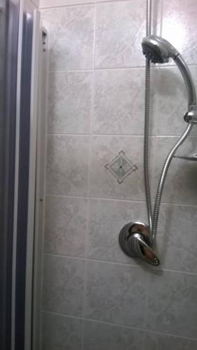 a shower with a shower head in a bathroom at Sicilian Seaside Retreat in Realmonte in Realmonte