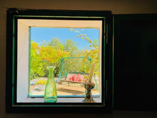 a framed picture of three vases in a window at Trulli di Ivana in Ostuni