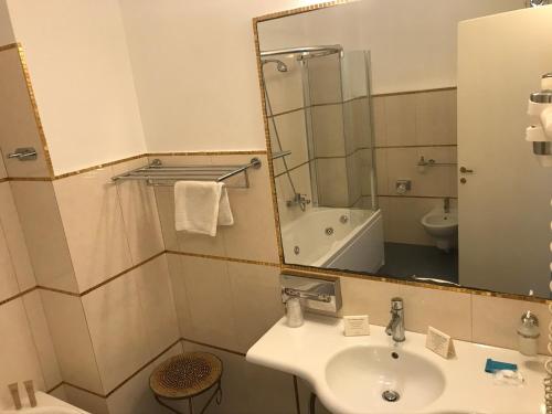 a bathroom with a sink and a mirror at Marina Holiday & Spa in Balestrate