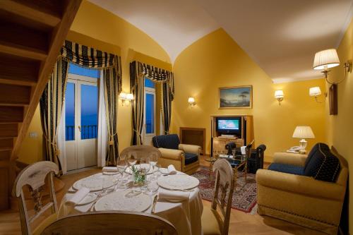 a living room with a table and chairs at Imperial Hotel Tramontano in Sorrento