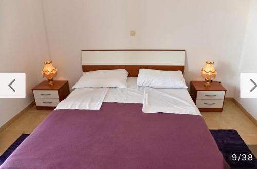 a bedroom with a large bed with two night stands at Villa D in Trogir