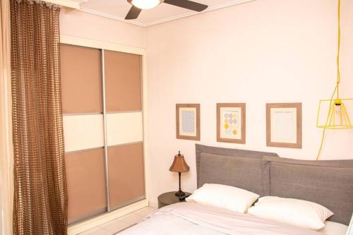a bedroom with a bed with a gray headboard at Sweet Home #Center# in Volos