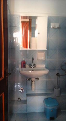 a bathroom with a sink and a toilet at MARGARITAS' ROOMS in Agios Gordios