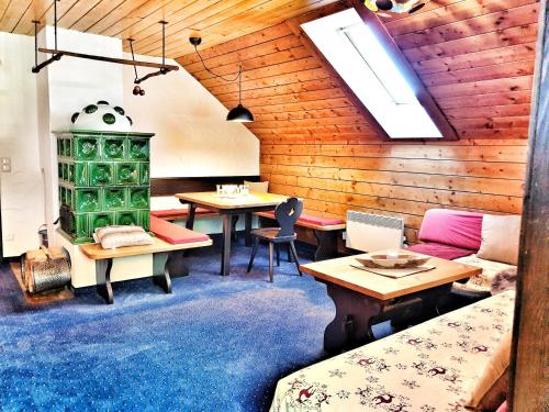 a room with wooden walls and tables and chairs at das Bergerleben in Sonnenalpe Nassfeld