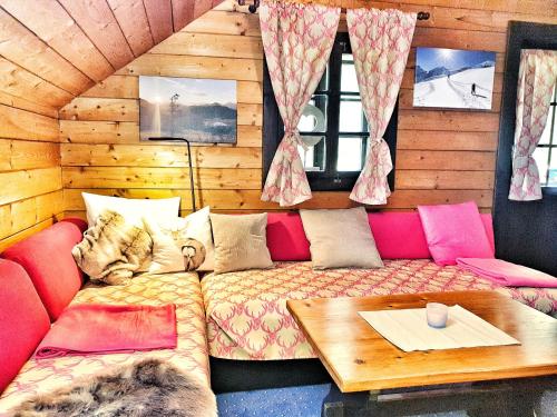 a living room with a couch and a table at das Bergerleben in Sonnenalpe Nassfeld