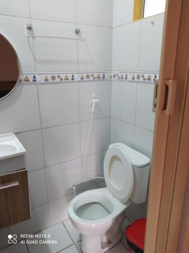 a small bathroom with a toilet and a sink at Pousada Belo Mar in Maceió