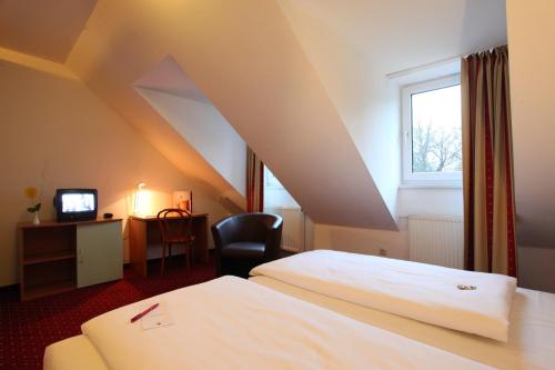 Cama ou camas em um quarto em Andante Hotel Erding