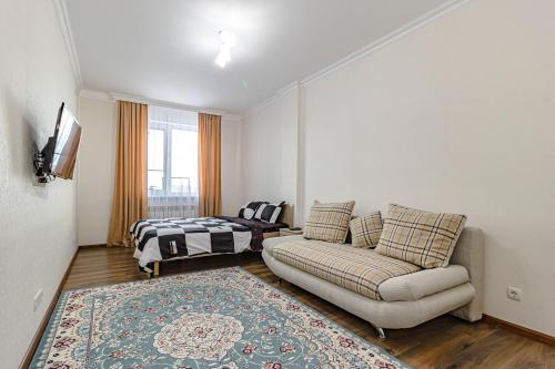a living room with a couch and a bed at BI CITY SEUOL 116 in Astana