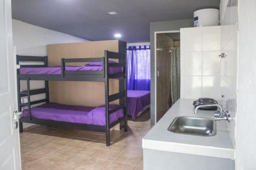 a kitchen with purple bunk beds and a sink at Rincón Azul in San Rafael