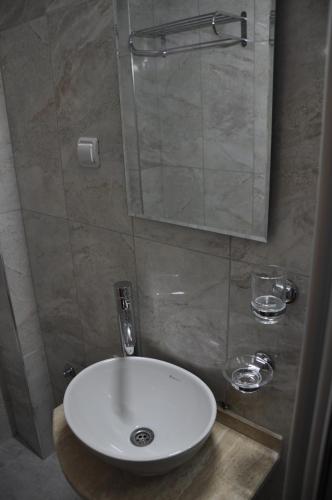 a bathroom with a white sink and a mirror at Sibel Hotel in Antalya