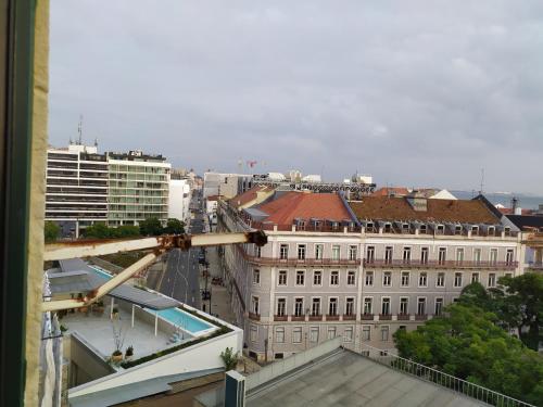 a view of a city from a building at Cenário Catita Hostel in Lisbon