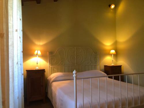 a bedroom with a bed and two lamps on tables at podere campanella in Viterbo