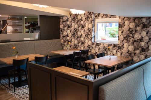 a dining room with wooden tables and chairs at Hotel Gerig in Wassen
