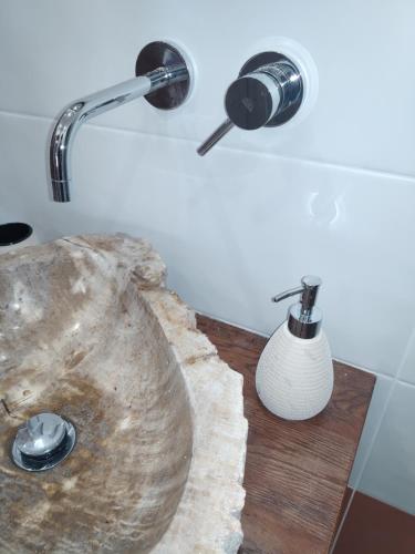 a bathroom with a sink and a lamp and a vase at Piccolo Paradiso in pieno centro Rivisondoli in Rivisondoli
