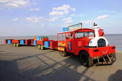 a toy train is parked on the beach at J&A Family Caravan Haven Mablethorpe in Mablethorpe