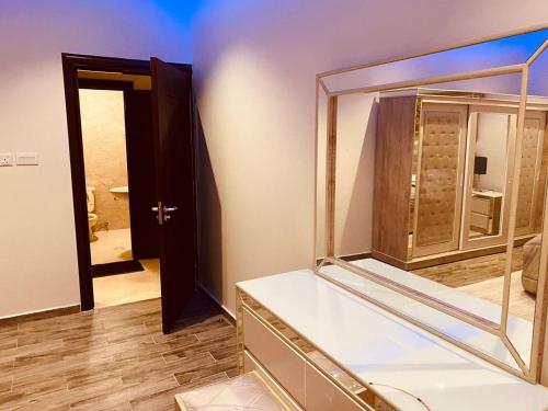 a dressing room with a mirror and a closet at الخزامى in Al Ahsa