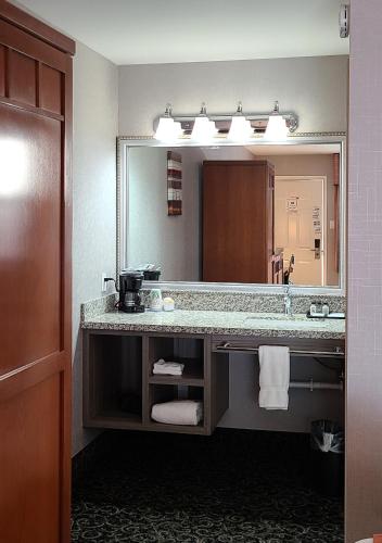 a bathroom with a sink and a large mirror at Dow Villa Motel in Lone Pine