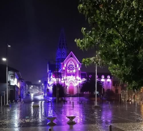 a lit up church with purple lights at night at Hotel LB - Los Balsos in Pasto