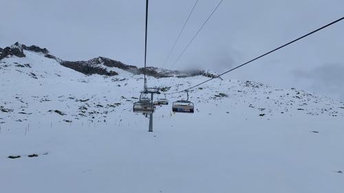 a pair of ski lift chairs on a snowy mountain at Residenz Panorama - Blatten bei Naters VS in Blatten bei Naters