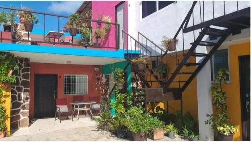 a balcony of a house with a staircase and a table at Depto Las Puertas de la Ria #4 in Campeche