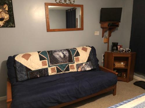 a couch with a quilt on it in a living room at McKinley View B&B in Trapper Creek